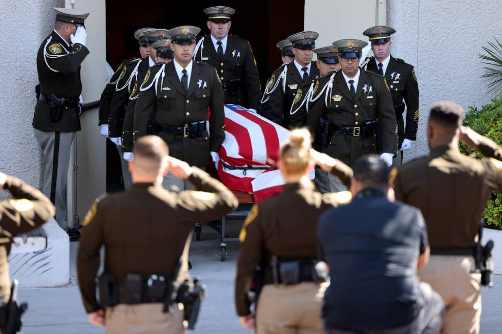 Metropolitan Police Department Honor Guard load the casket of Las Vegas police Detective Justin ...