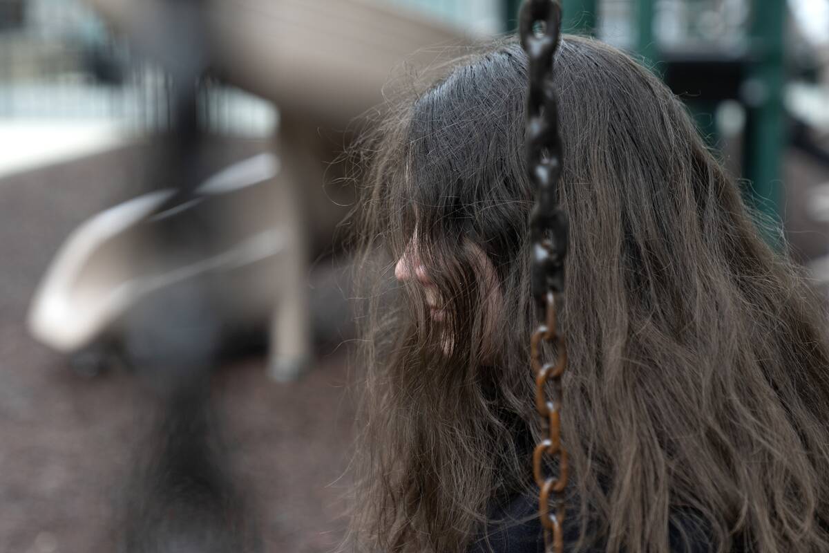 Amelia, 16, sits for a portrait in a park near her home in Illinois on Friday, March 24, 2023. ...