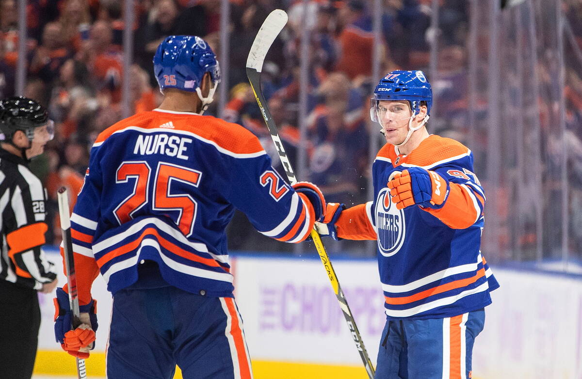 Edmonton Oilers' Darnell Nurse (25) and Connor McDavid (97) celebrate a goal against the Vegas ...