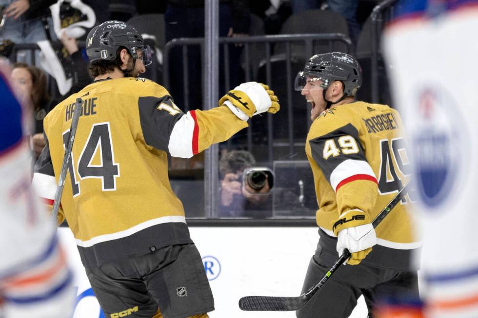 Golden Knights defenseman Nicolas Hague (14) and center Ivan Barbashev (49) celebrate after Bar ...