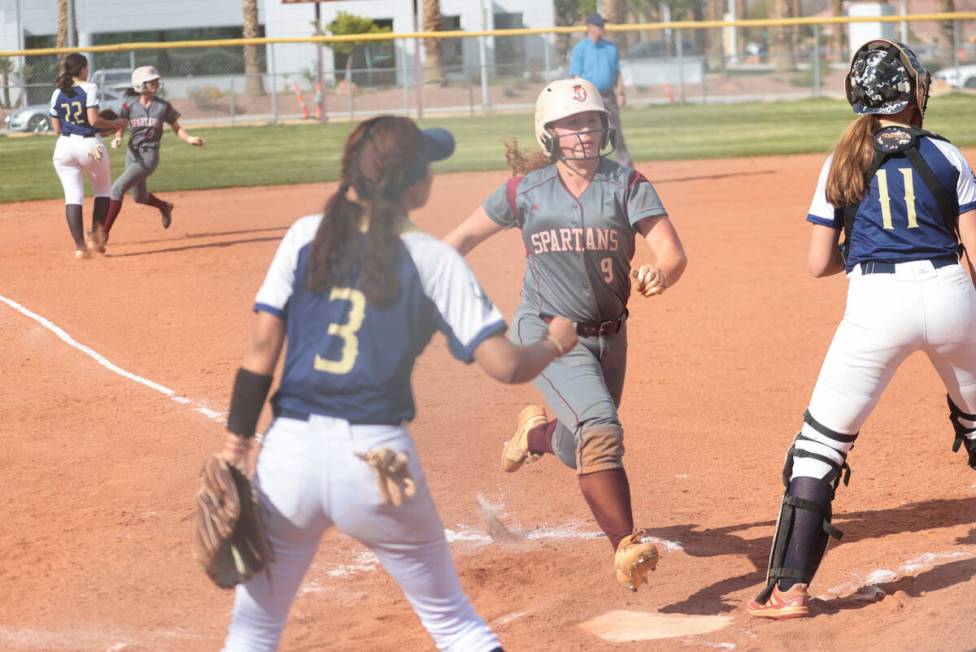 Cimarron-Memorial's Haileigh Siegel (9) scores a run against Spring Valley during a softball ga ...