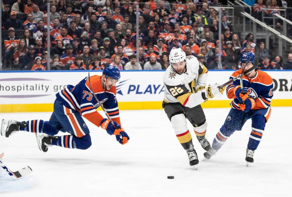 Vegas Golden Knights' Michael Amadio (22) works for the puck between Edmonton Oilers' Vincent D ...