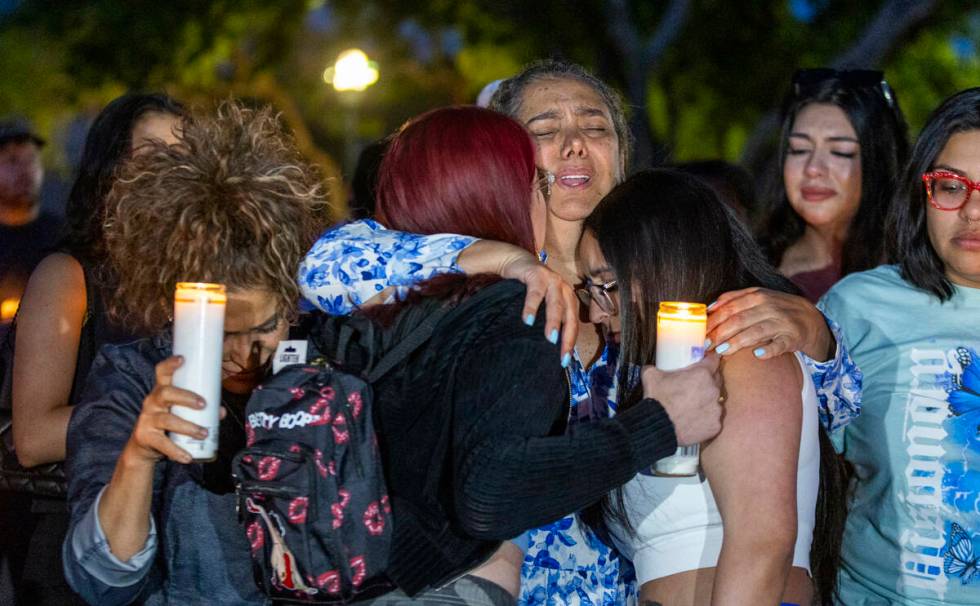 Maria Regina Lacerda Gomes, center, is comforted during a vigil for her daughter Tabatha Tozzi, ...