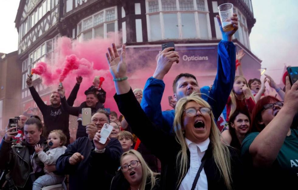 Supporters of the Wrexham FC soccer team celebrate their promotion to the Football League in Wr ...