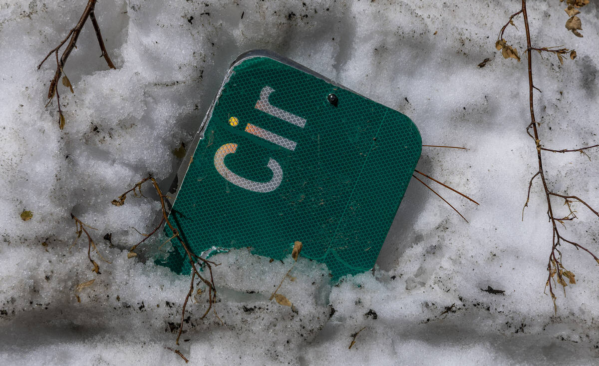 Snow is still high in places and covers a road sign in the Rainbow subdivision within Kyle Cany ...