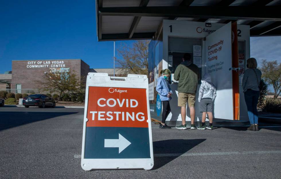 FILE - People wait and are served for COVID-19 testing at the Veterans Memorial Community Cente ...