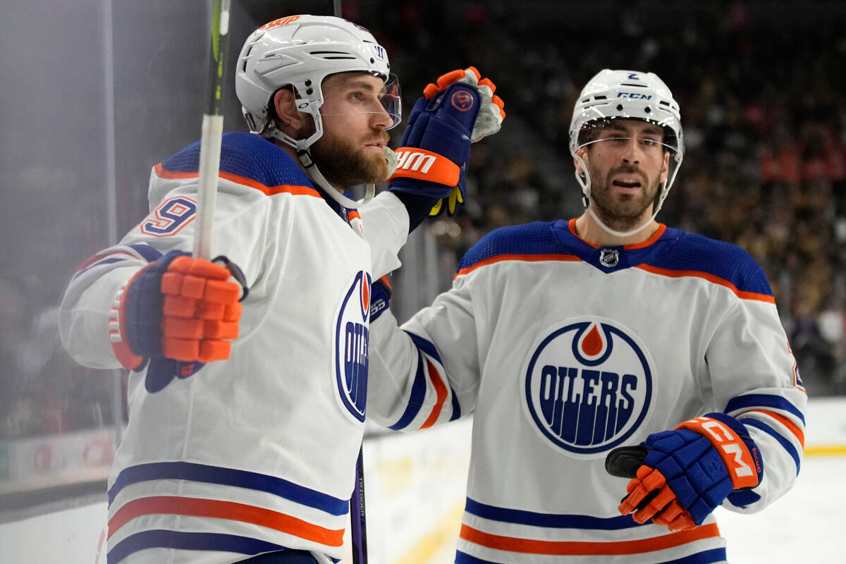 Edmonton Oilers center Leon Draisaitl, left, celebrates after scoring against the Vegas Golden ...