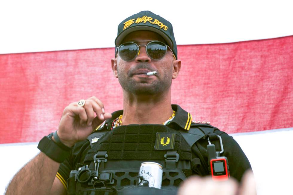 FILE - Proud Boys leader Henry "Enrique" Tarrio wears a hat that says The War Boys du ...