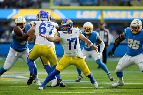 Los Angeles Rams quarterback Baker Mayfield (17) tosses the ball during the first half of an NF ...