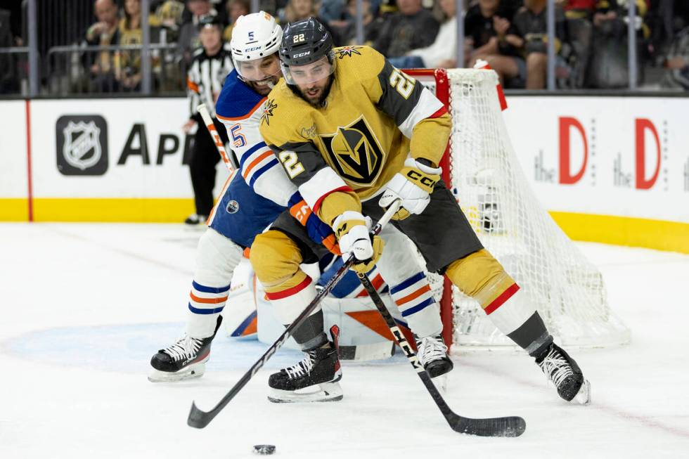 Golden Knights right wing Michael Amadio (22) and Edmonton Oilers defenseman Cody Ceci (5) batt ...