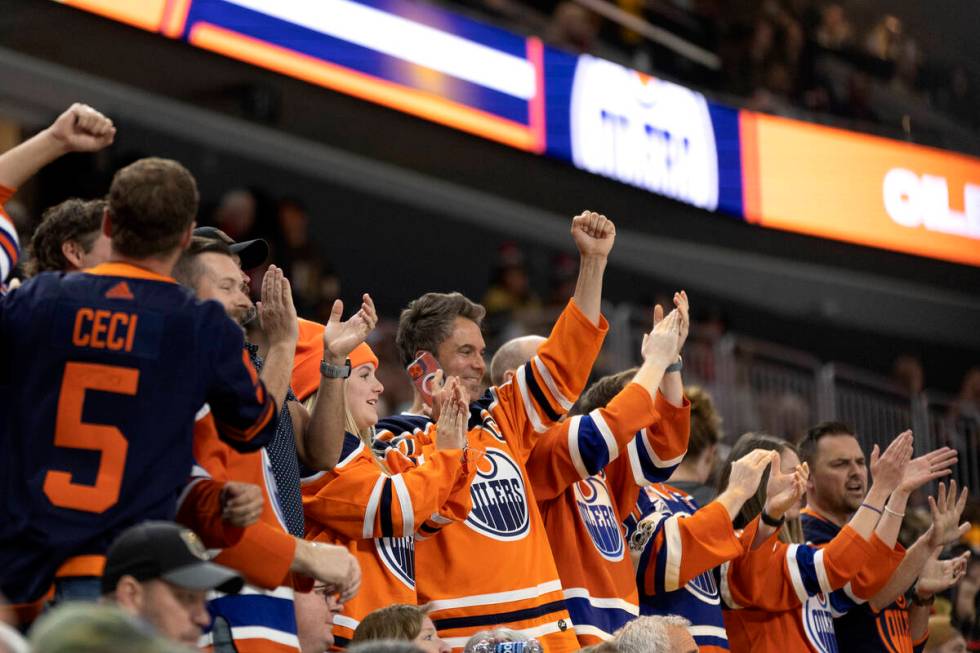 Edmonton Oilers fans celebrate after their team’s fourth goal during the first period in ...