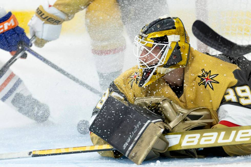 Golden Knights goaltender Laurent Brossoit (39) saves the puck during the second period in Game ...