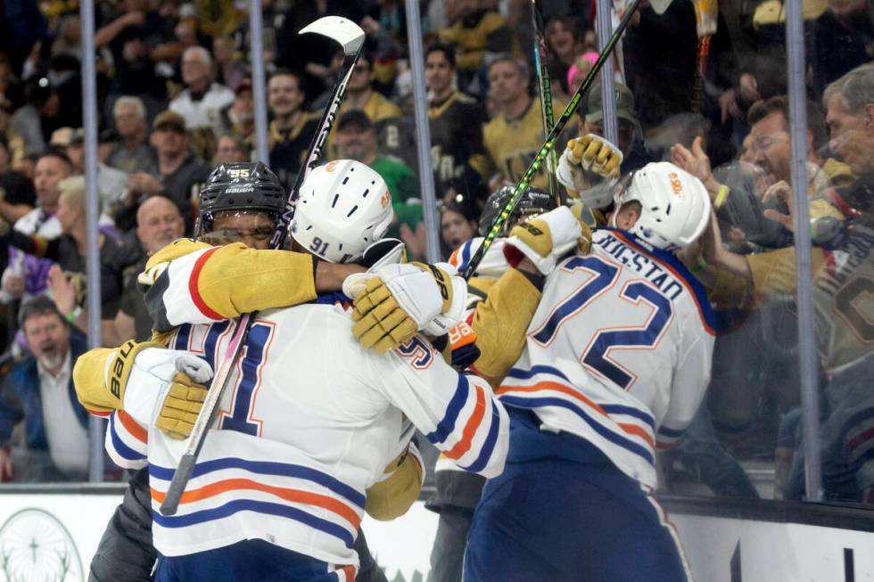 Golden Knights right wing Keegan Kolesar (55) fights with Edmonton Oilers left wing Evander Kan ...