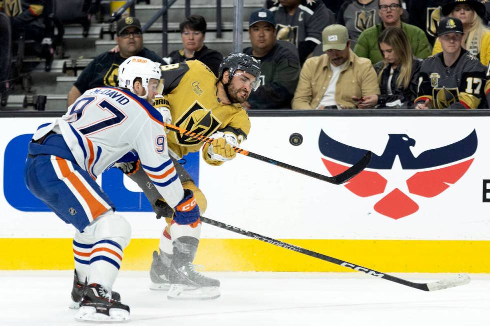 Golden Knights left wing William Carrier (28) shoots while Edmonton Oilers center Connor McDavi ...