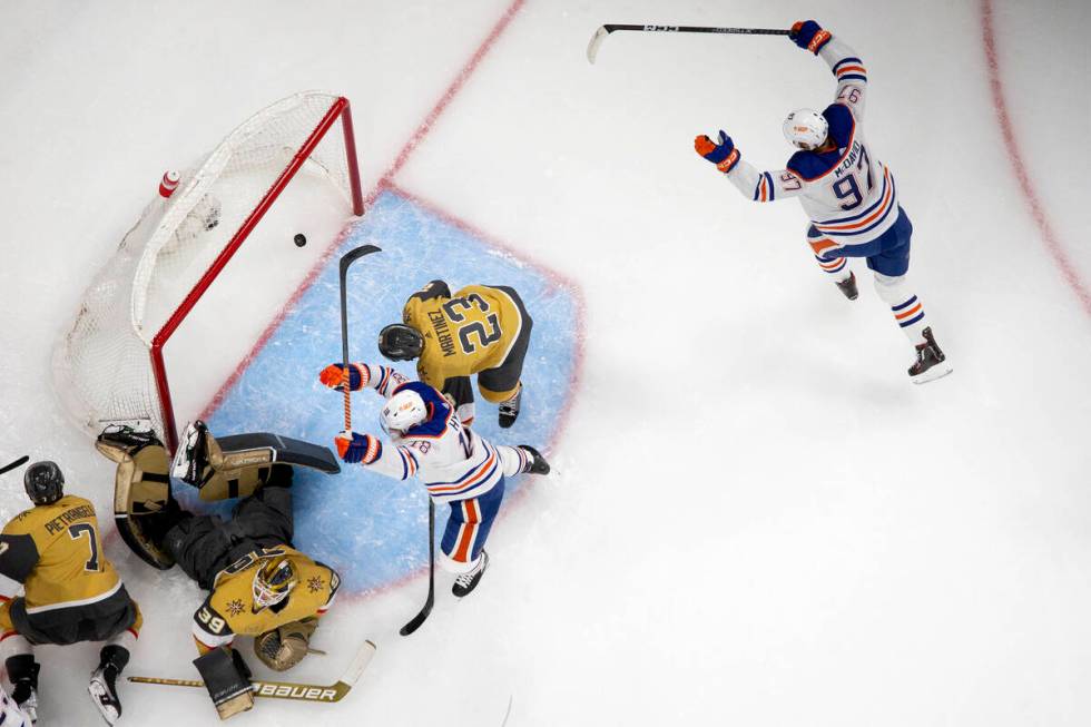 Edmonton Oilers left wing Zach Hyman (18) and center Connor McDavid (97) celebrate after their ...