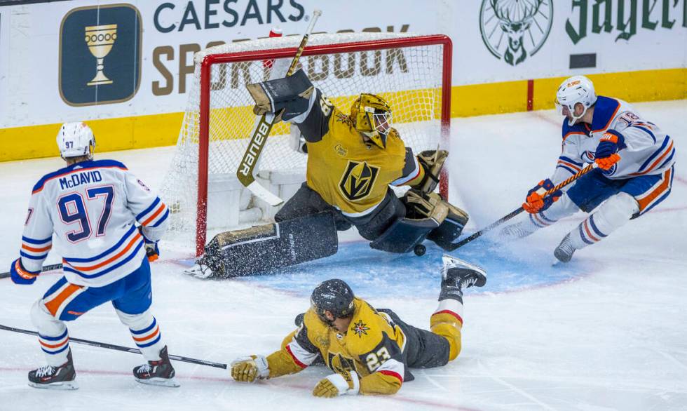 Golden Knights goaltender Laurent Brossoit (39) stops a shot from Edmonton Oilers left wing Zac ...