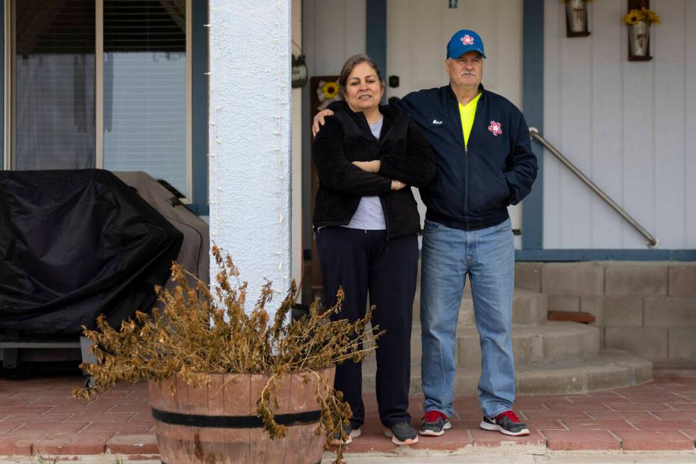 Alma Perez, left, with her husband Mario, stand outside of their home in the Lytle Ranch neighb ...