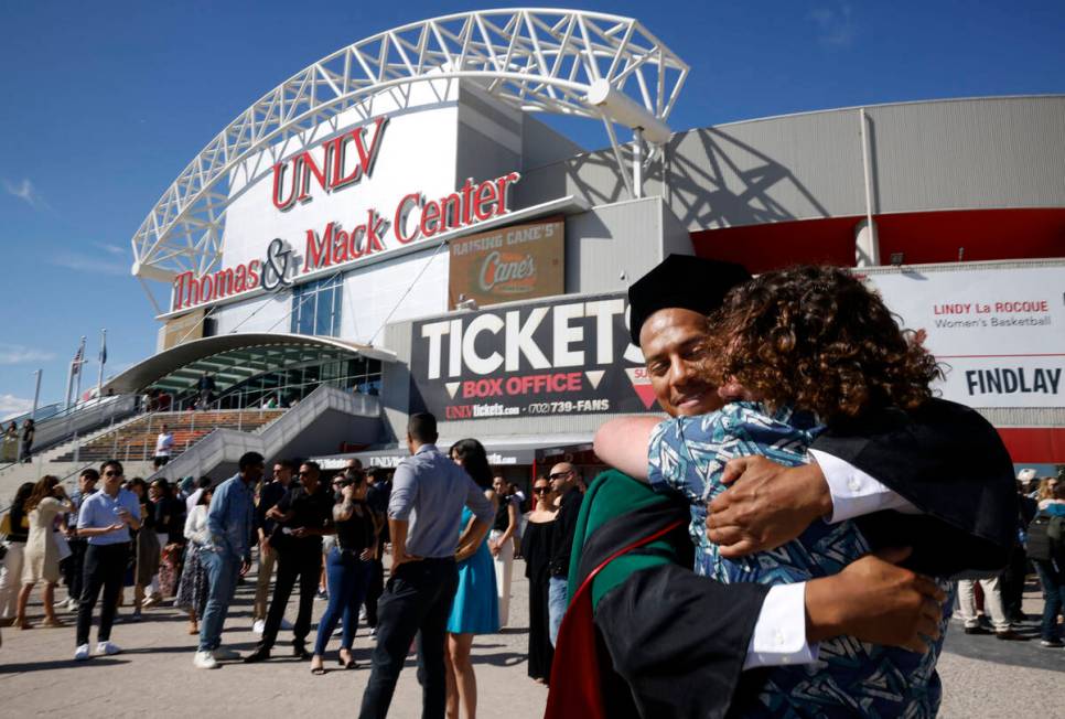 Jabre Millon receives a hug from Scott Brauner of La Verne Calif. after the commencement and ac ...