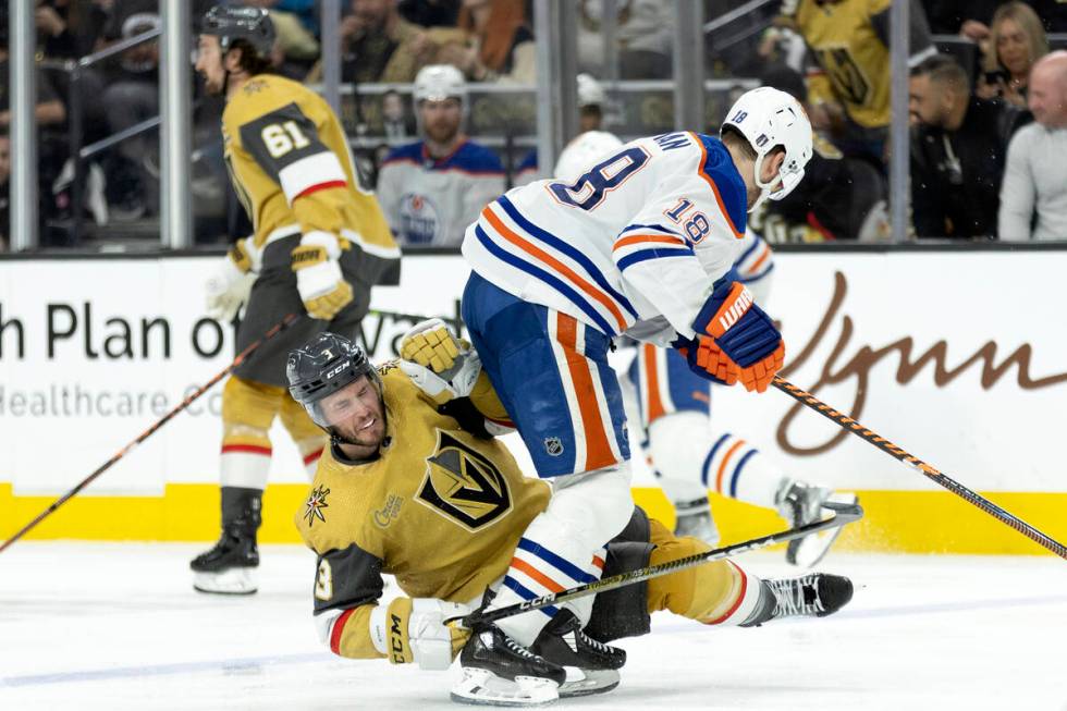 Golden Knights defenseman Brayden McNabb (3) collides with Edmonton Oilers left wing Zach Hyman ...