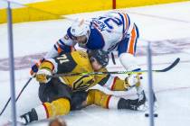 Golden Knights center William Karlsson (71) is pushed down to the ice by Edmonton Oilers defens ...