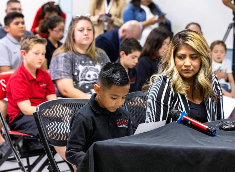 Roman Lomeli, a second grade student at Mountain View Christian School, reads his testimony as ...