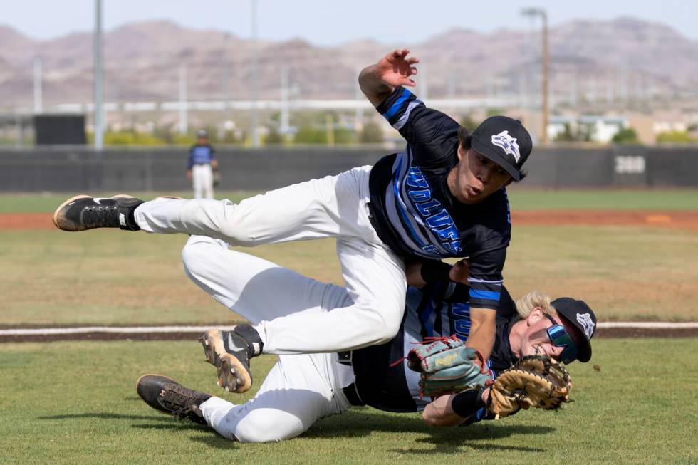 Basic’s Tate Southisene, above, and Cooper Sheff collide while going for a foul ball dur ...
