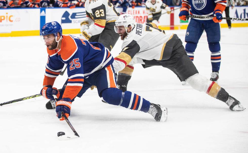 Vegas Golden Knights' Alex Pietrangelo (7) trips Edmonton Oilers' Darnell Nurse (25) during the ...