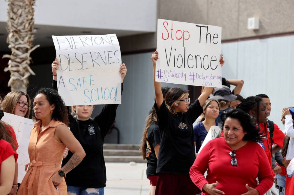 Eldorado High School students Savannah Card, 15, holding sign left, and Sara Torrico, 15, holdi ...