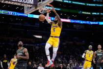 Los Angeles Lakers forward LeBron James (6) dunks over Minnesota Timberwolves guard Mike Conley ...