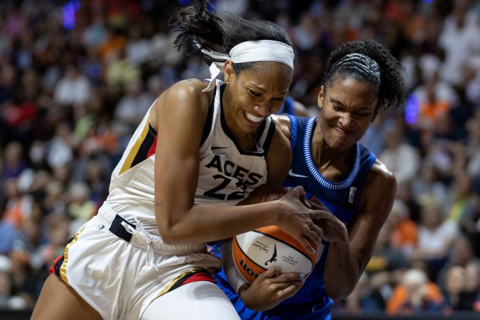 Las Vegas Aces forward A'ja Wilson (22) drives toward the hoop while Connecticut Sun forward Al ...