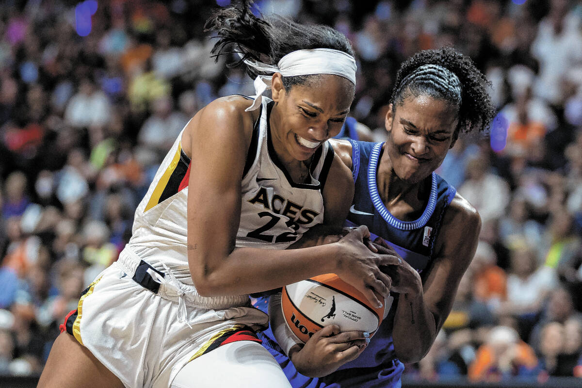 Las Vegas Aces forward A'ja Wilson (22) drives toward the hoop while Connecticut Sun forward Al ...