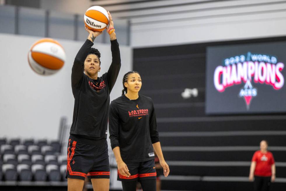 Las Vegas Aces center Candace Parker, left, shoots the basketball near Kiah Stokes during a tea ...