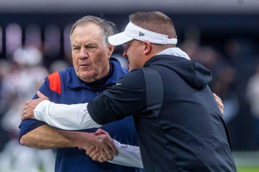 Raiders Head Coach Josh McDaniels greets New England Patriots Head Coach Bill Belichick during ...