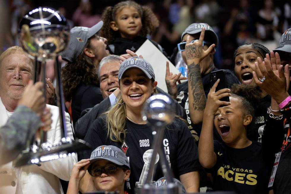 Las Vegas Aces owner Mark Davis, left, and head coach Becky Hammon stand alongside their cheeri ...