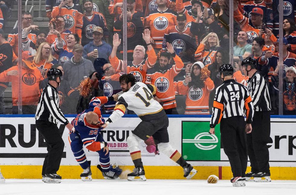 Vegas Golden Knights' Nicolas Hague (14) and Edmonton Oilers' Darnell Nurse (25) fight during t ...