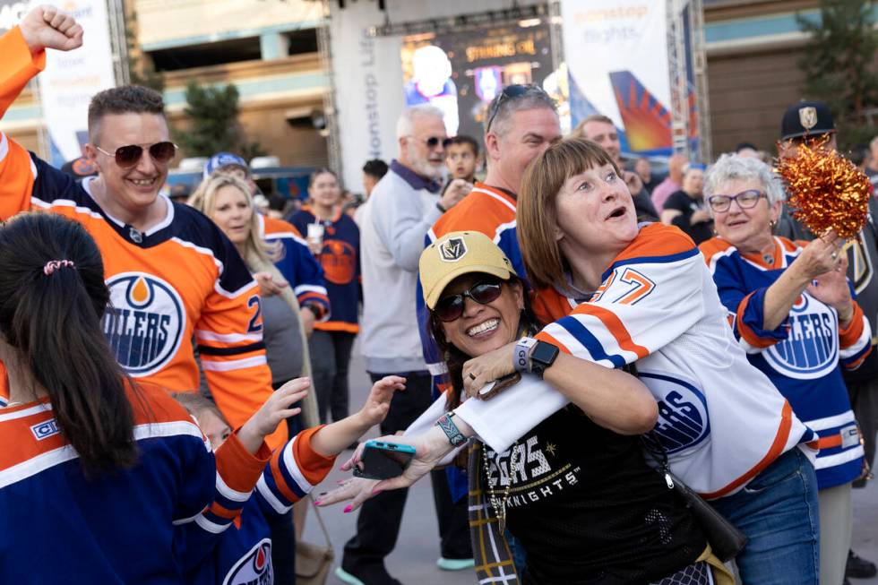 Dion Glenn, center left, a Golden Knights fan, interrupts Edmonton Oilers fans while they cheer ...