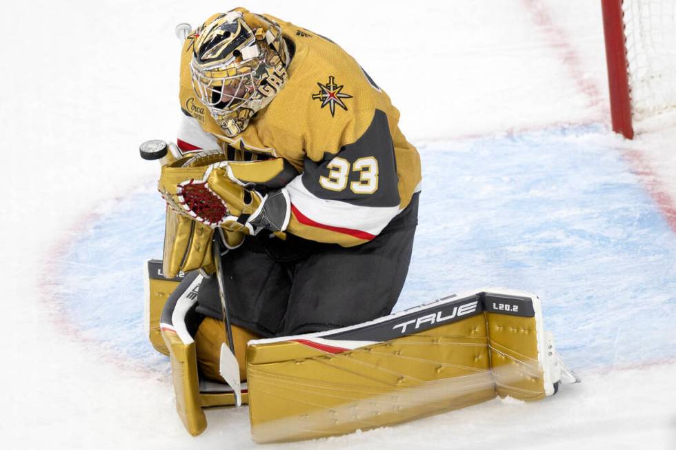 Golden Knights goaltender Adin Hill (33) saves the puck during the third period in Game 5 of an ...