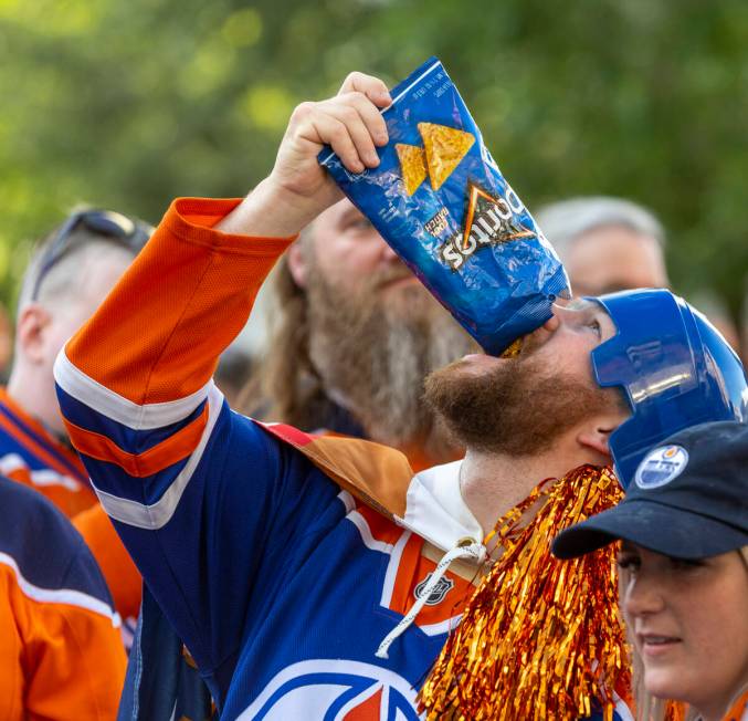 An Edmonton Oilers fan enjoys some Doritos outside before facing the Golden Knights in Game 5 o ...