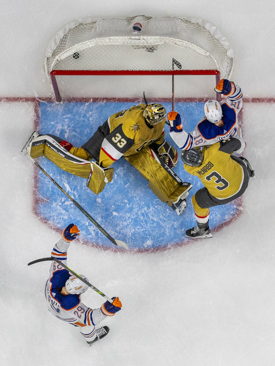 Golden Knights goaltender Adin Hill (33) misses a diving block as Edmonton Oilers left wing Zac ...