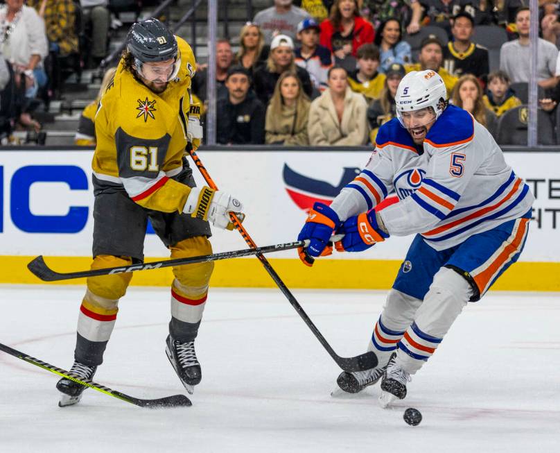 Golden Knights right wing Mark Stone (61) shoots past Edmonton Oilers defenseman Cody Ceci (5) ...