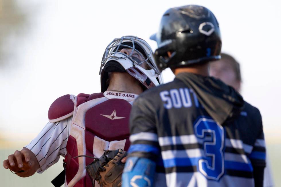 Desert Oasis catcher Jake Cook, left, prepares to make the game-winning catch on a foul ball hi ...