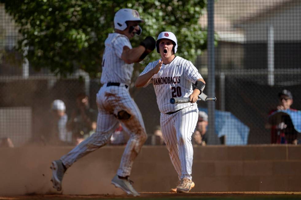 Desert Oasis’ Jake Cook, left, and Ethan Kelly (20) celebrate after Cook scored during a ...