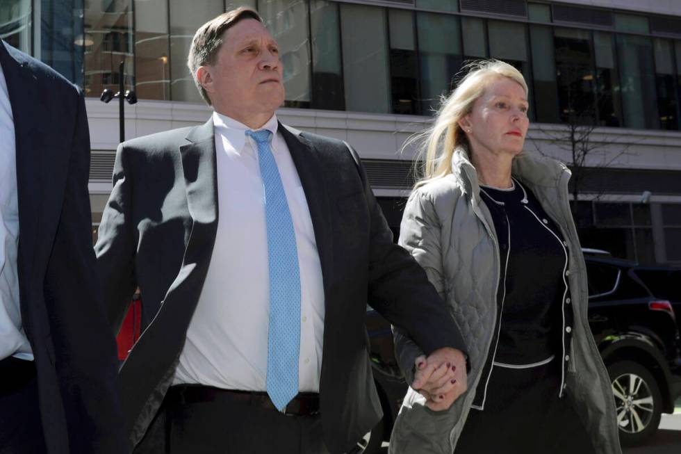 John Wilson arrives at federal court with his wife, Leslie, in Boston on April 3, 2019, to face ...