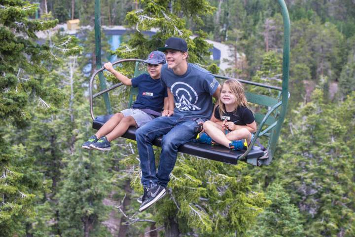 Quinn Bunevith, left, summer attendant Spencer Miller and Rory Kirk ride the Sherwood ski lift ...