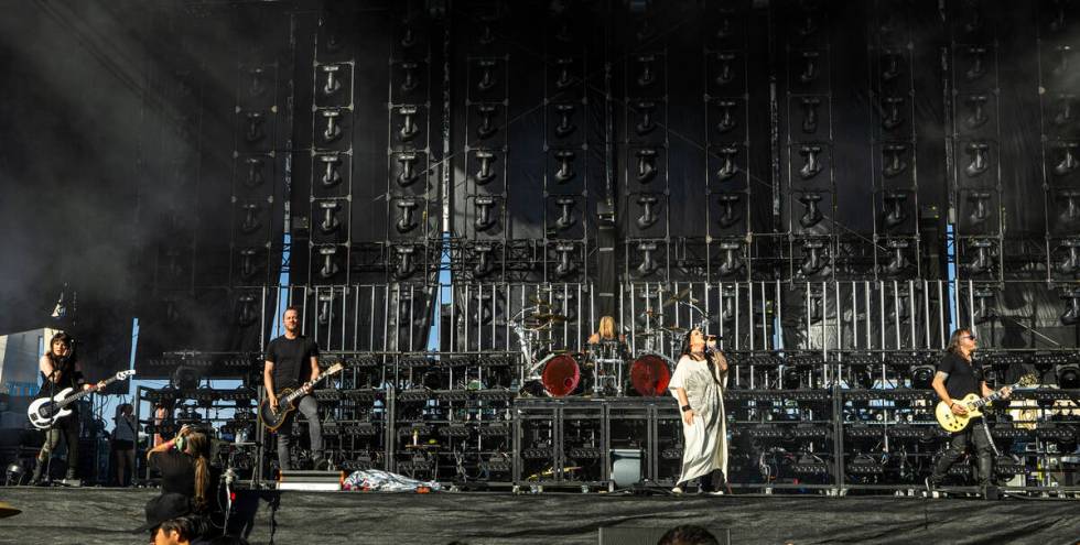 Evanescence lead singer Amy Lee, center, performs with the band during the Sick New World festi ...