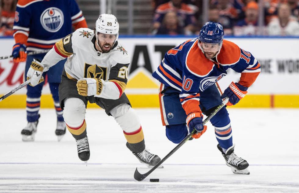 Vegas Golden Knights' Chandler Stephenson (20) chases Edmonton Oilers' Derek Ryan (10) during t ...