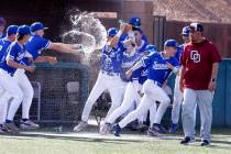 Bishop Gorman High School players celebrate their 10-3 win against Desert Oasis High during the ...