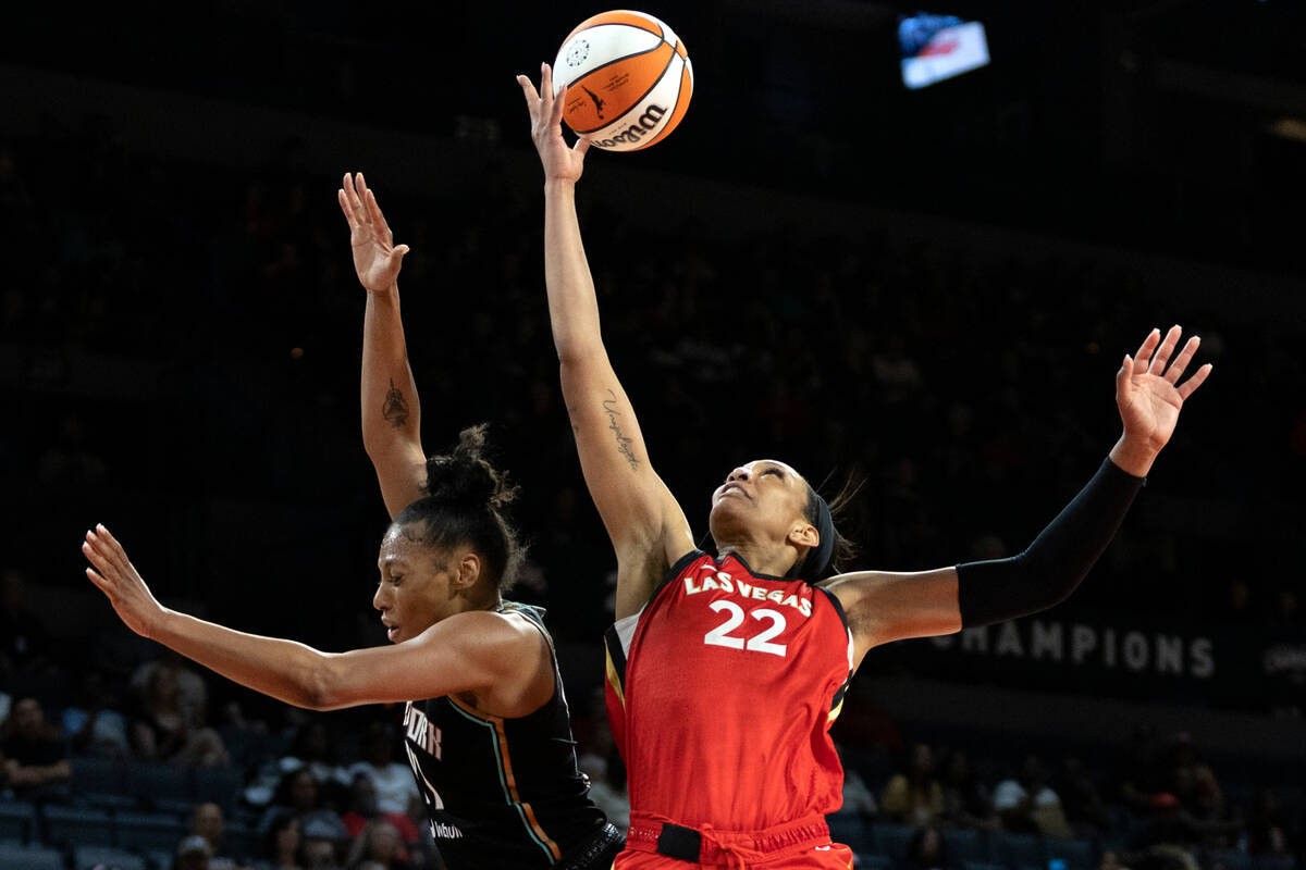 Aces forward A'ja Wilson (22) snags a rebound against New York Liberty forward Betnijah Laney ( ...