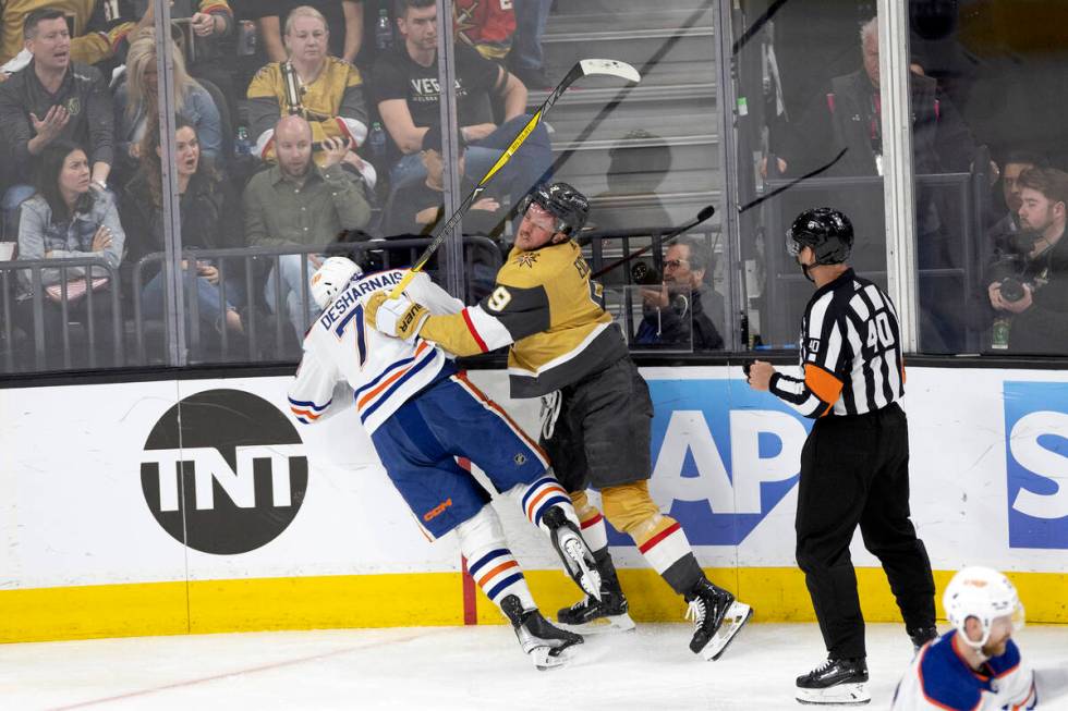 Golden Knights center Jack Eichel (9) shoves Edmonton Oilers defenseman Vincent Desharnais (73) ...