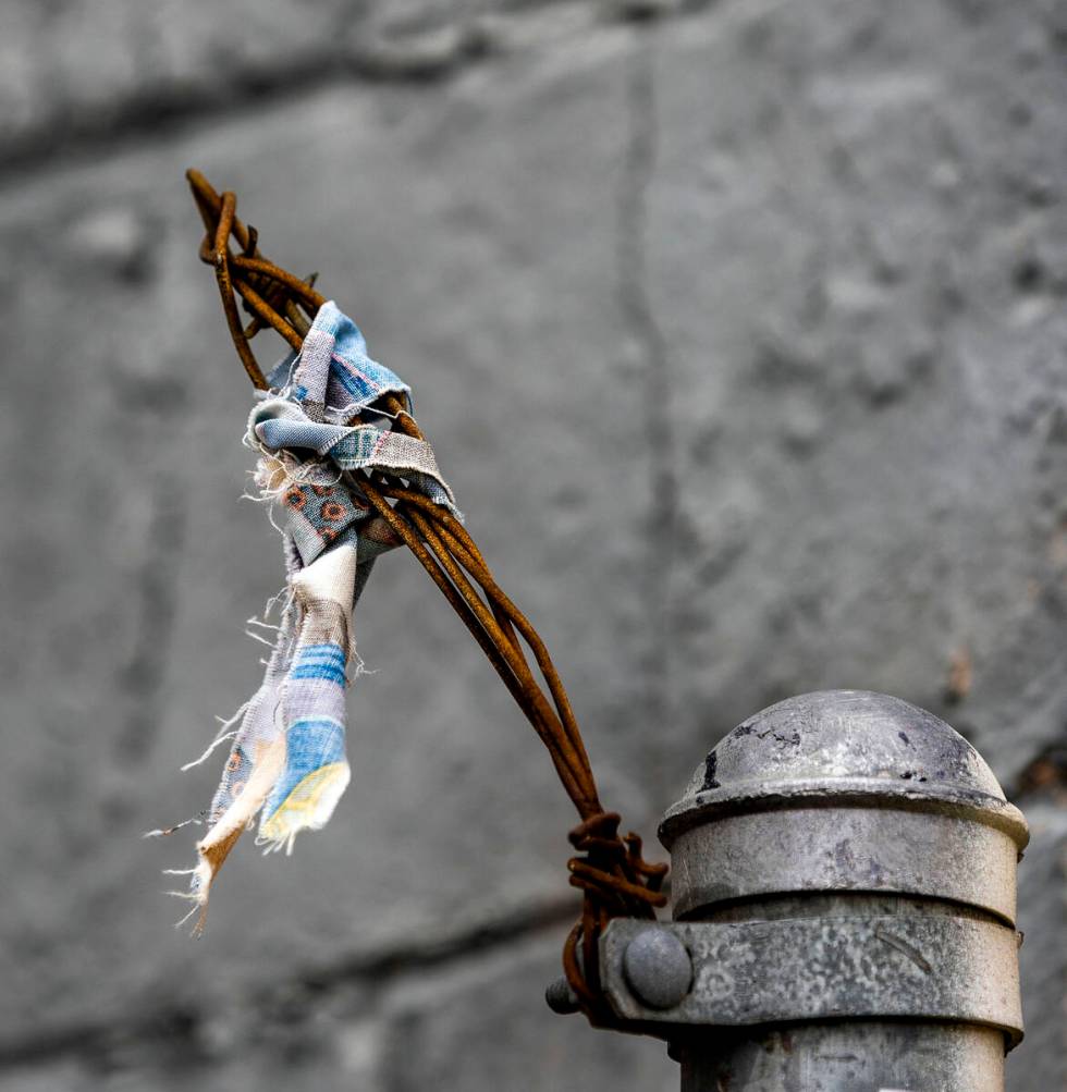 Pieces of wire and cloth on a fence about a former business along West Bonanza Road on Tuesday, ...